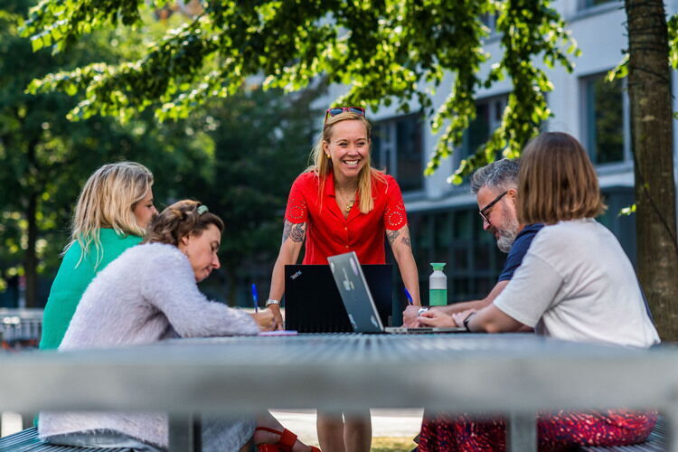 Medewerkers van stad Antwerpen rond een tafel aan het werk.